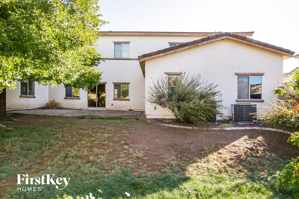 a white house with a yard and a tree
