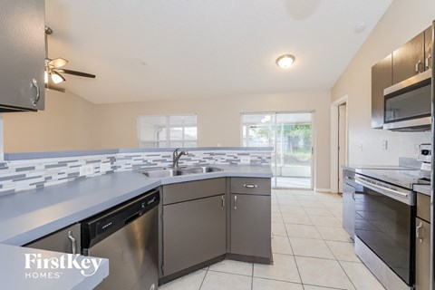 the kitchen is clean and ready to use with stainless steel appliances