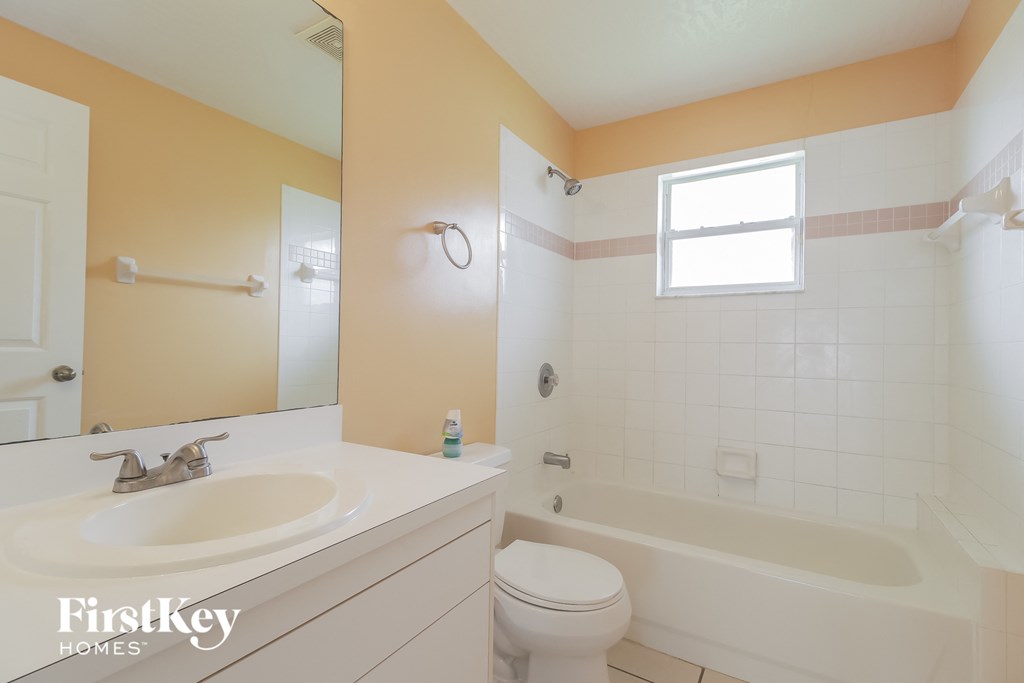 a bathroom with a sink toilet and a tub