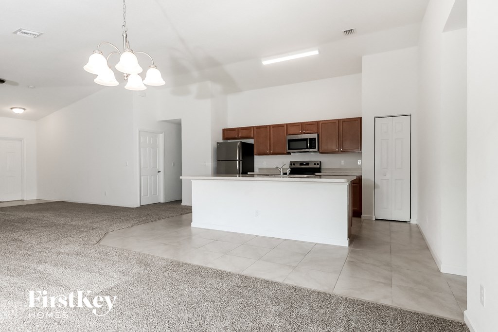 a white kitchen with a large island in the middle of it