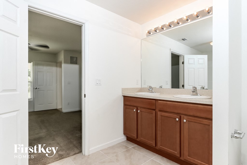 a bathroom with two sinks and a large mirror