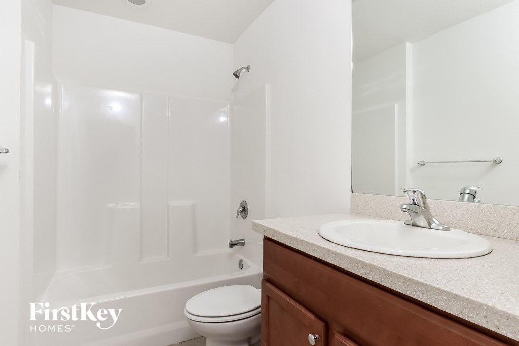a bathroom with a sink and a toilet and a shower