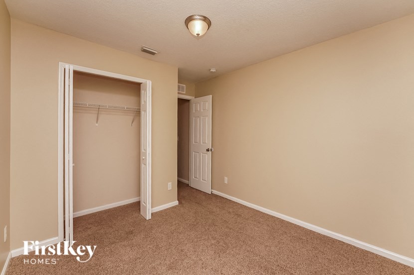 a bedroom with a closet and a door to a closet