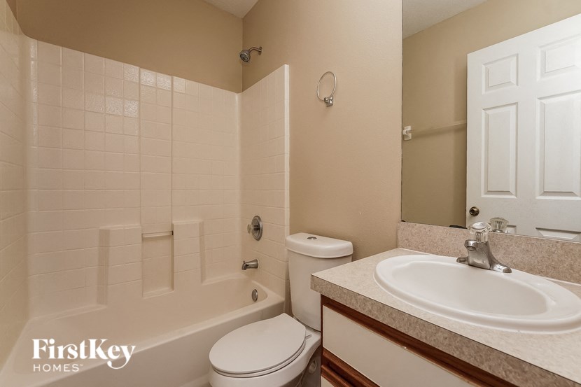 a bathroom with a sink toilet and a bath tub
