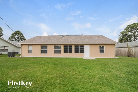 the front of a house with a large grassy yard