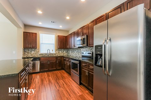 a kitchen with stainless steel appliances and wooden cabinets