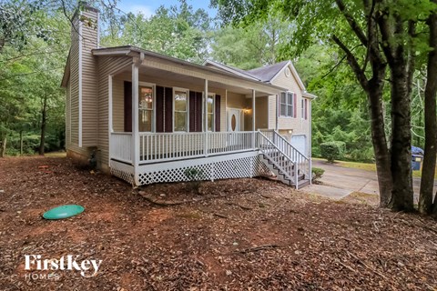 a small house with a porch and a frisbee on the ground