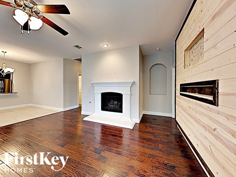 the living room has a fireplace and hardwood floors