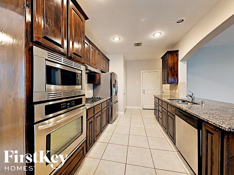 a kitchen with stainless steel appliances and wooden cabinets