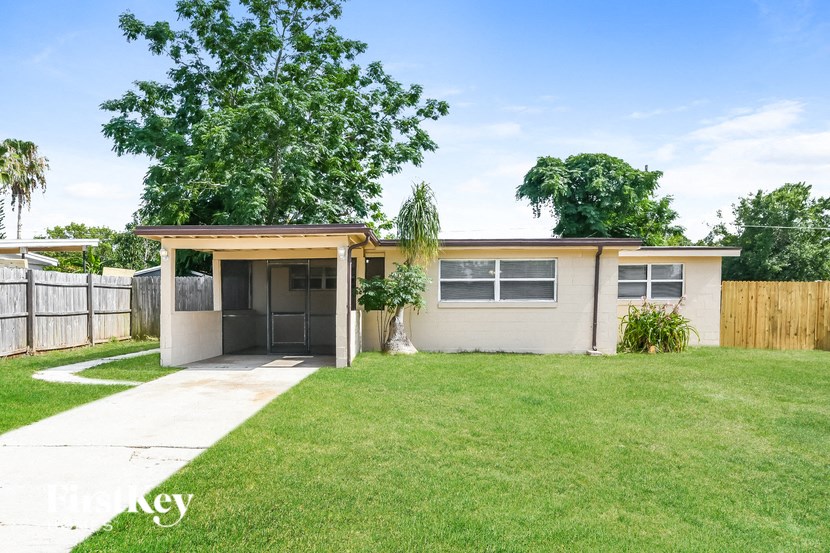 a small house with a lawn and a garage