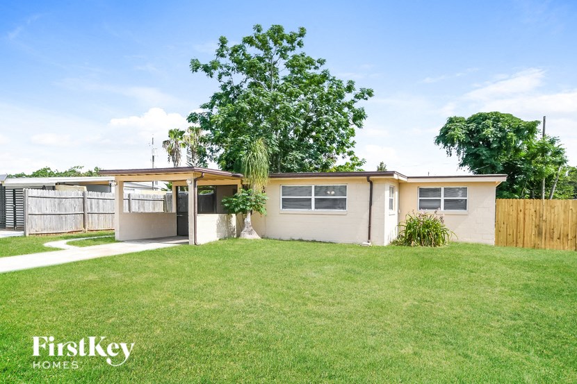 a house with a lawn and a tree in front of it