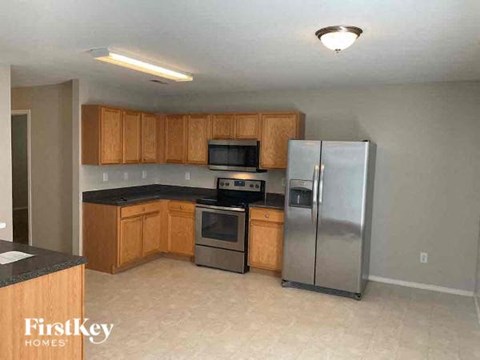a kitchen with stainless steel appliances and wooden cabinets