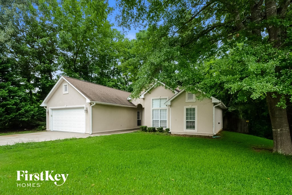 a white house with a yard and some trees