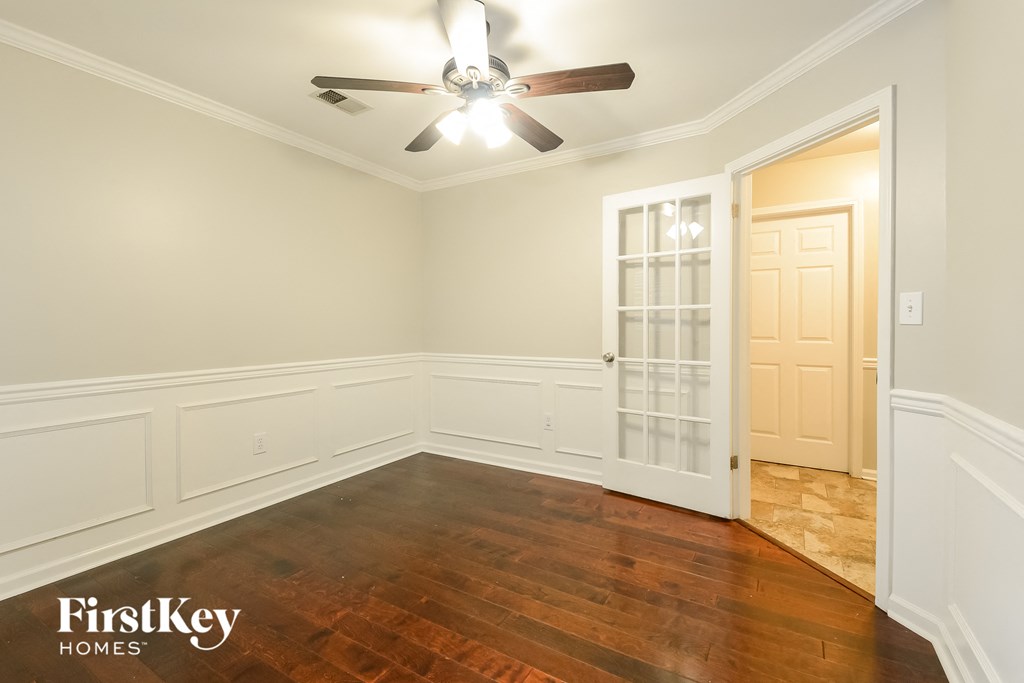 a dining room with wood flooring and a ceiling fan