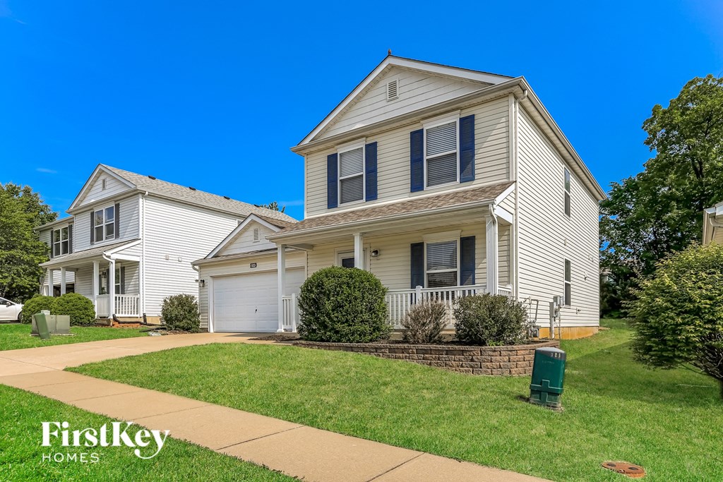 a white house with a sidewalk in front of it