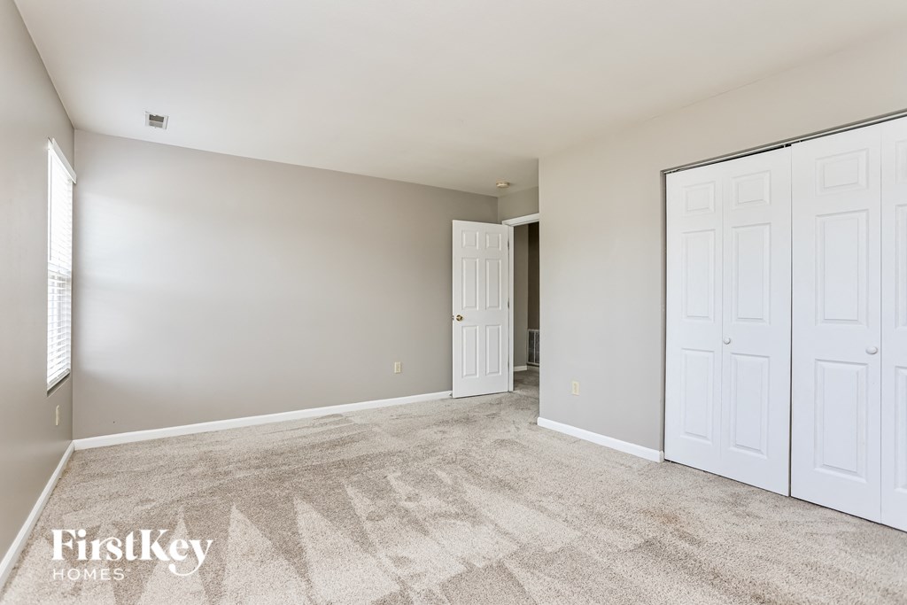 a bedroom with two closets and a door to a hallway