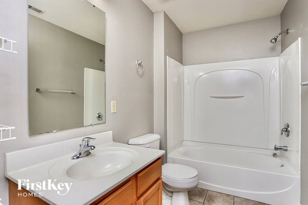 a bathroom with a sink toilet and shower and a bath tub