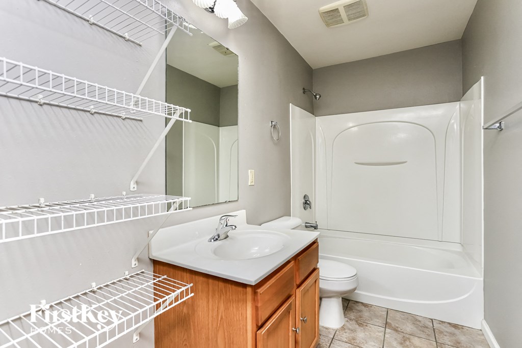 a bathroom with a sink and a shower and a toilet