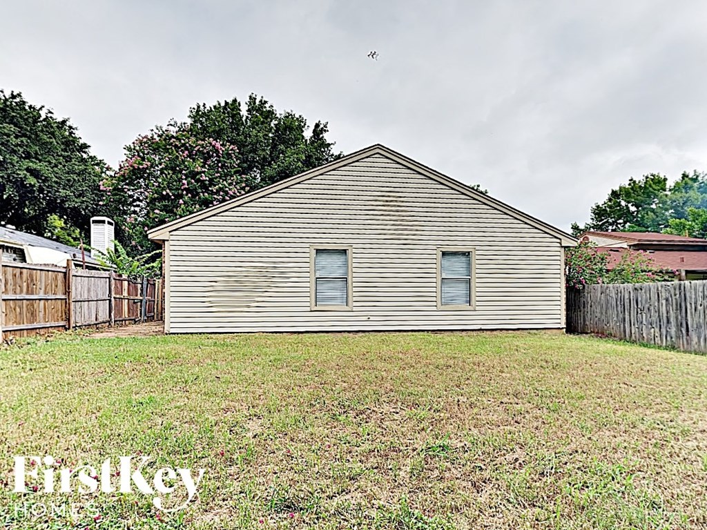 A house with a fence in front of it.