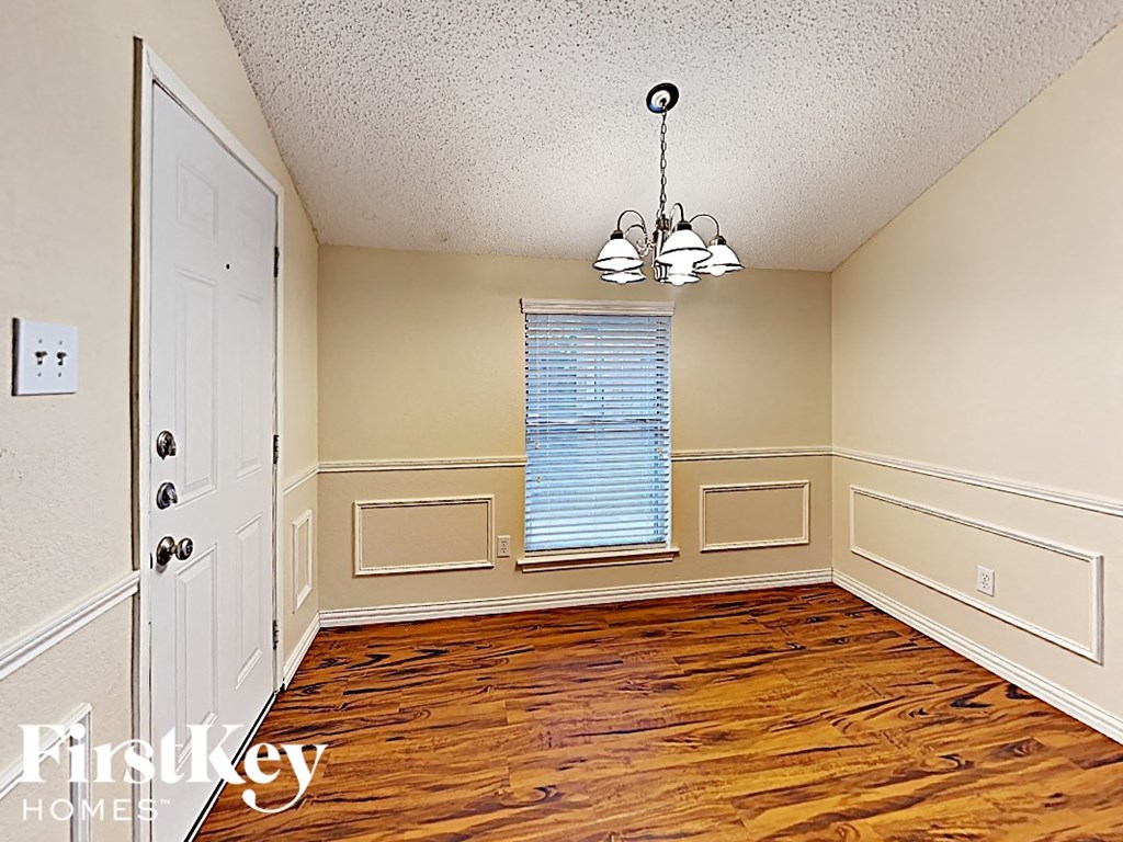 A room with wooden floors and a white door.