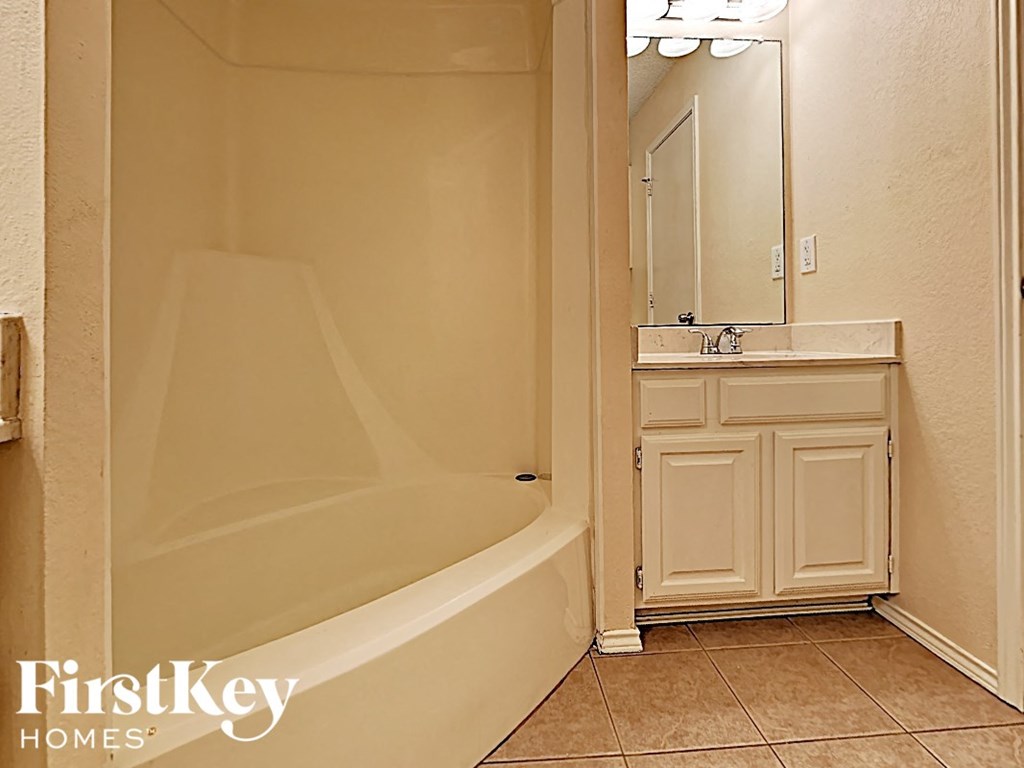 A bathroom with a tub and sink.