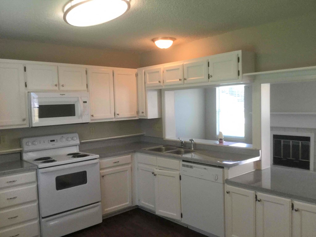 a kitchen with white appliances and white cabinets