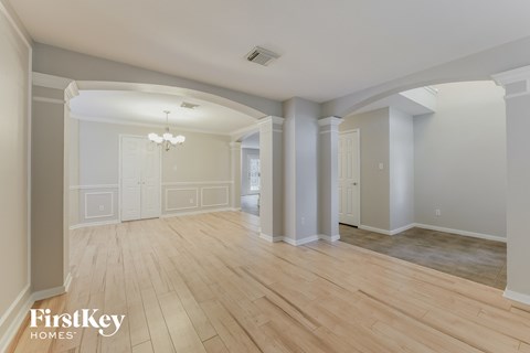 the living room and dining room with hardwood flooring