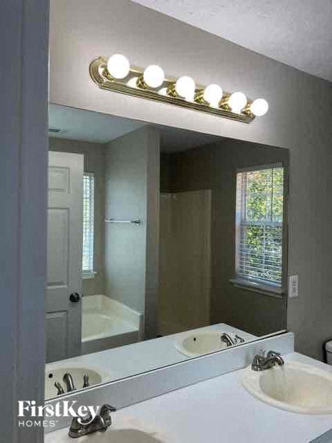 a bathroom with a white sink and a mirror