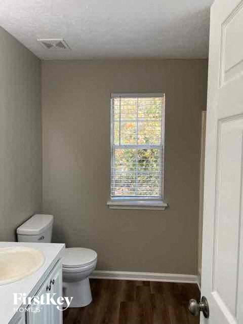a small bathroom with a toilet and a window