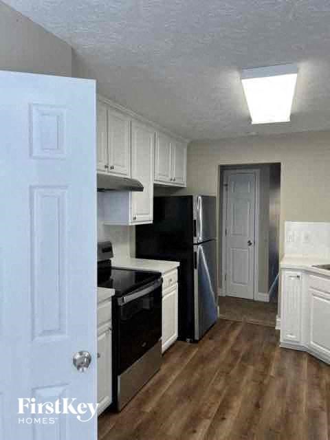 a kitchen with a stove and a refrigerator