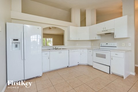 a white kitchen with white appliances and white cabinets