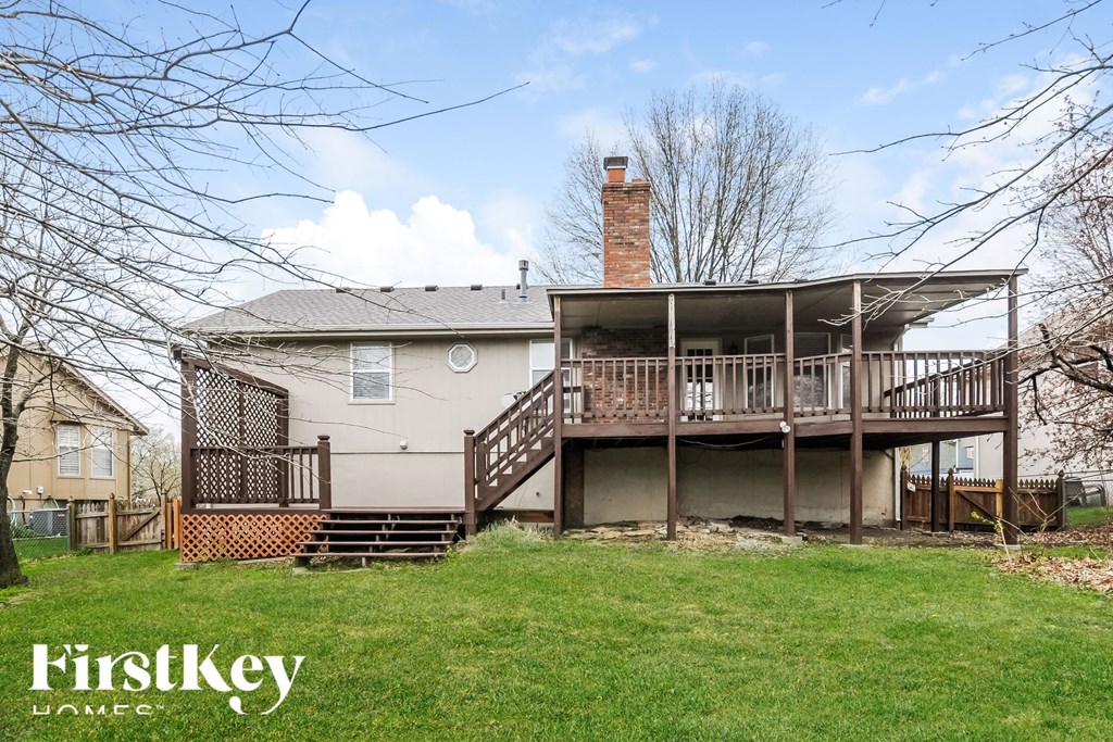 A house with a large deck and a chimney.
