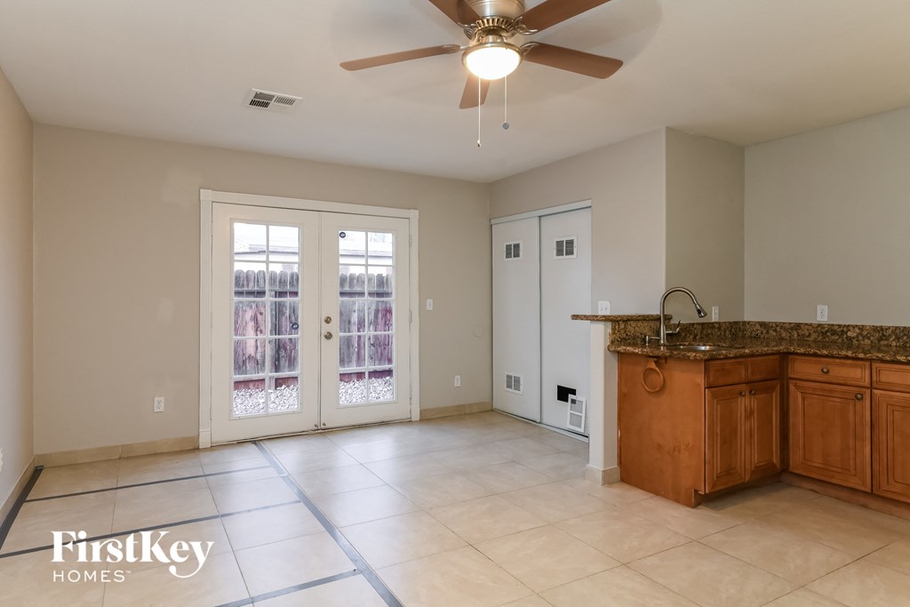 a kitchen with an island and a ceiling fan