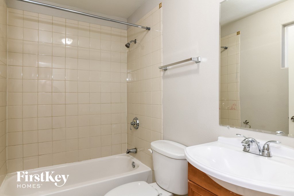 a bathroom with a sink toilet and a tub