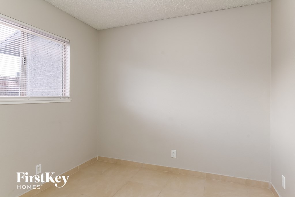 the living room of an empty house with a window