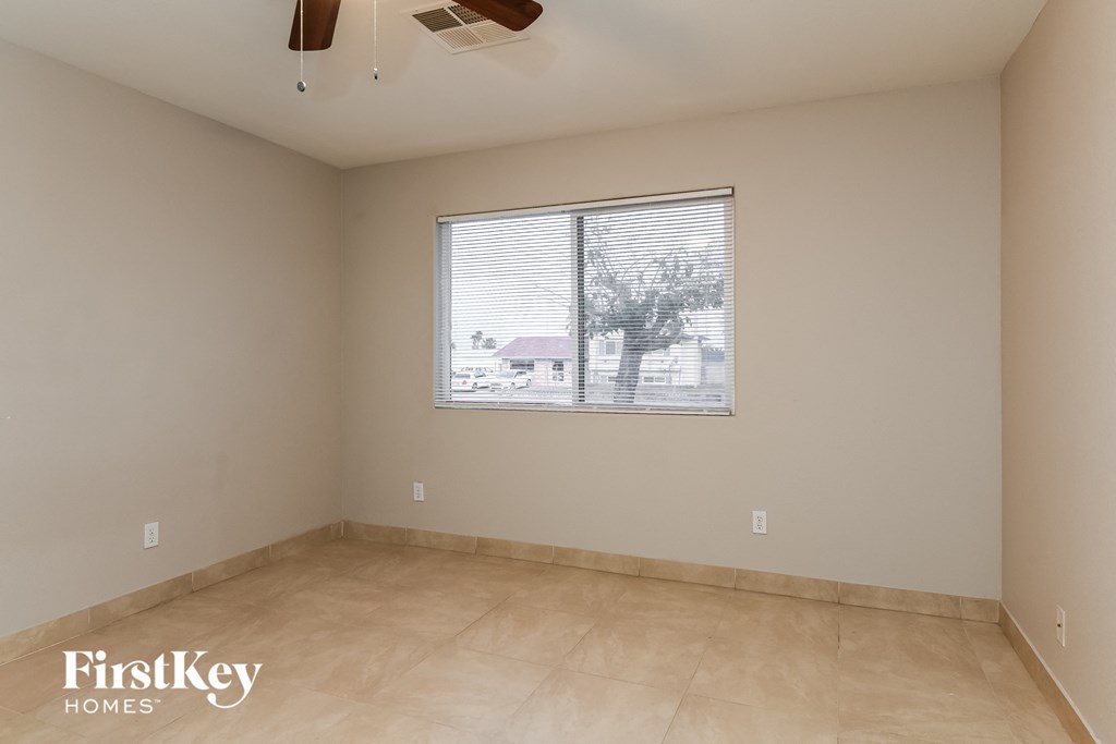 the living room of an empty house with a large window