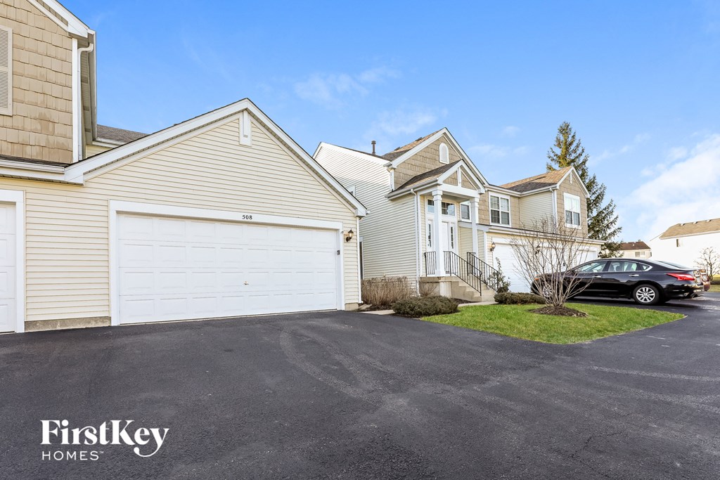 a white garage door in front of a row of houses