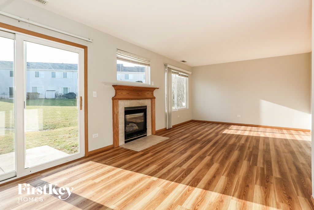 a living room with a fireplace and wooden floors