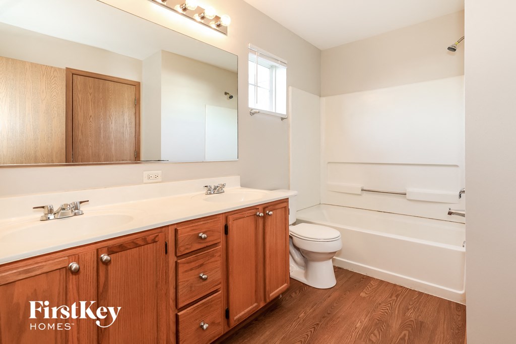 a bathroom with a toilet and a sink and a mirror