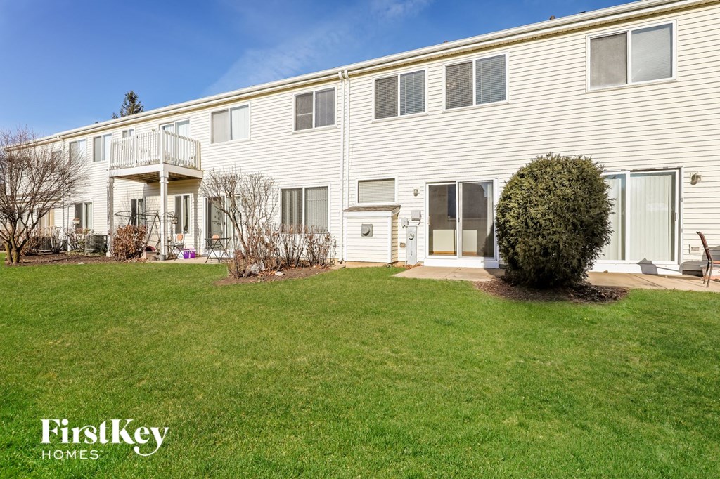 a large white house with a yard in front of it