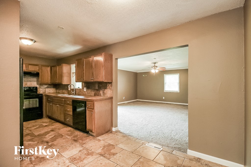 an empty kitchen and living room with an empty floor