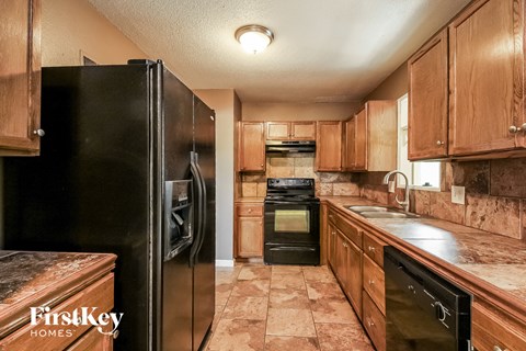 a kitchen with black appliances and wooden cabinets