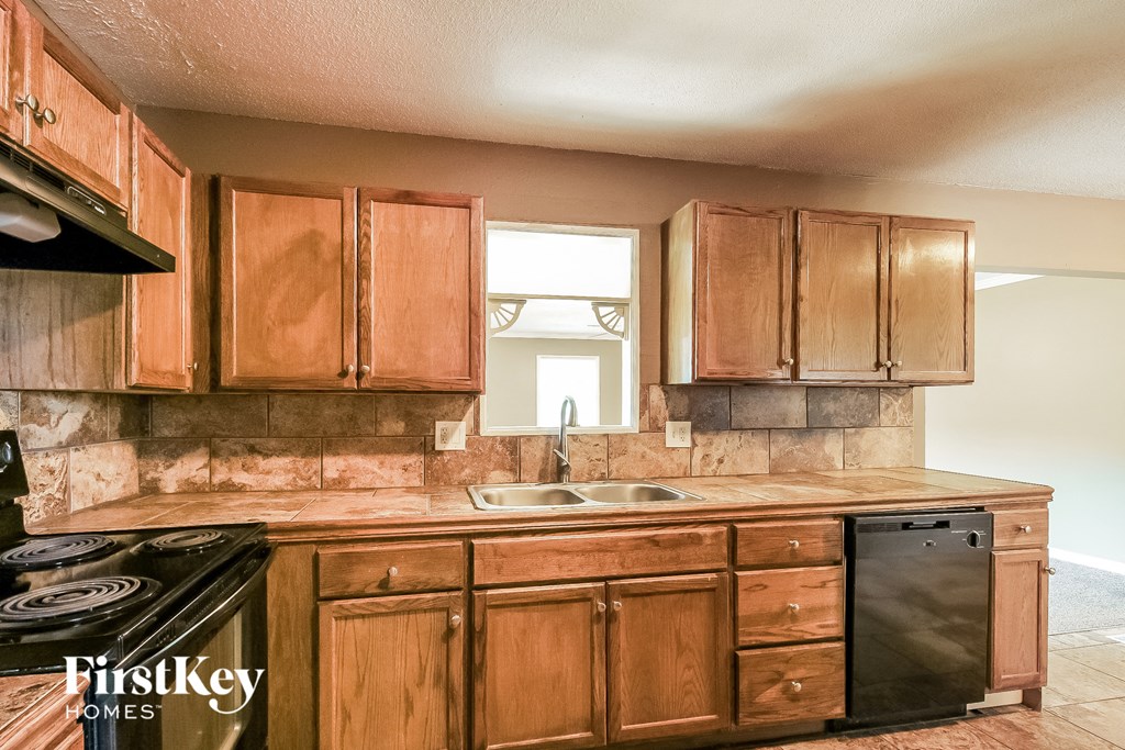 a kitchen with wooden cabinets and a sink