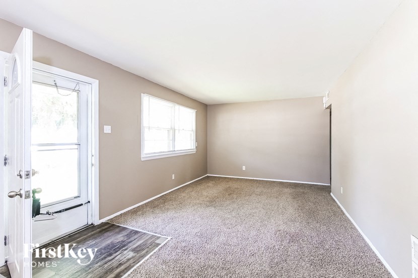 an empty room with a door and a window