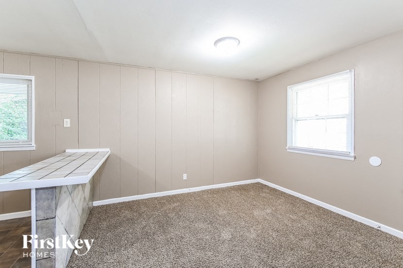an empty room with a desk and a window