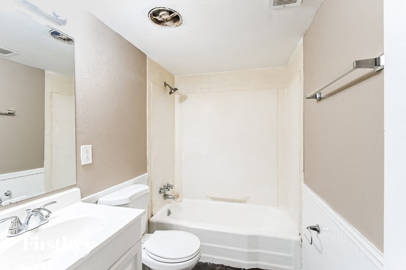 a bathroom with a sink toilet and a bath tub