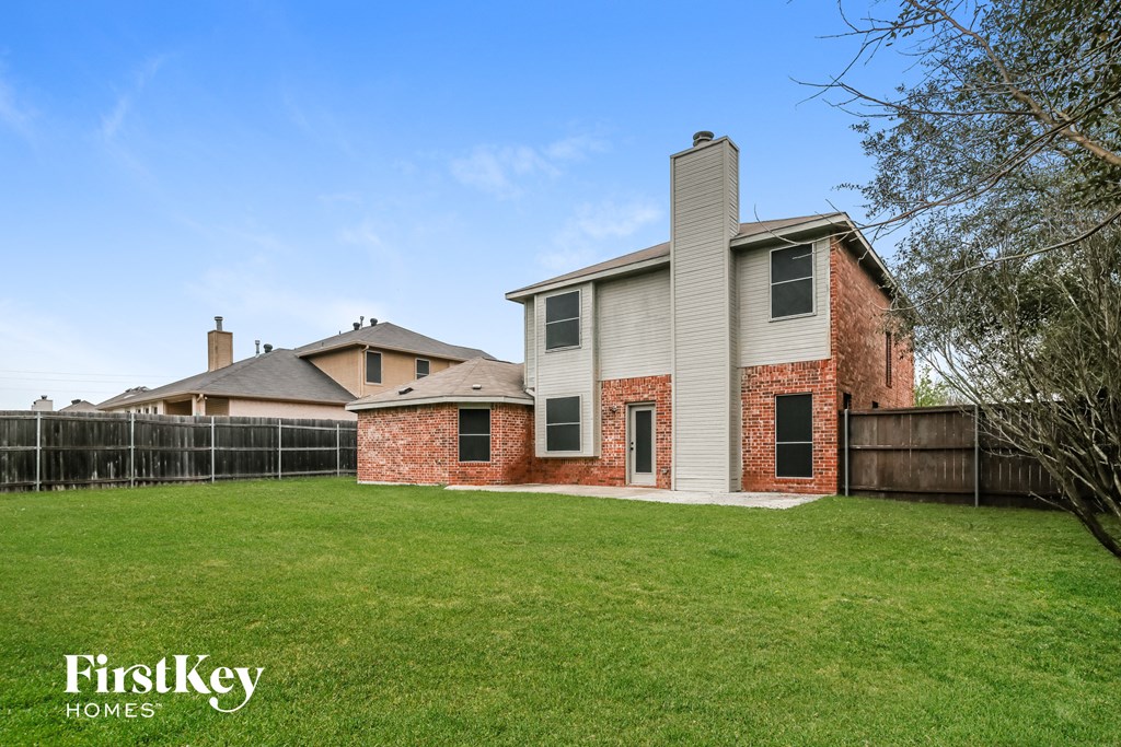 a house with a yard and a fence