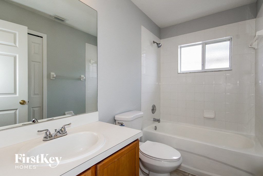 an empty bathroom with a sink toilet and shower