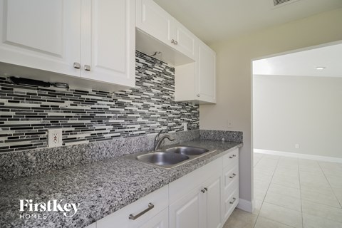 A kitchen with a sink and a counter top.