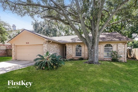 A house with a tree in front of it.